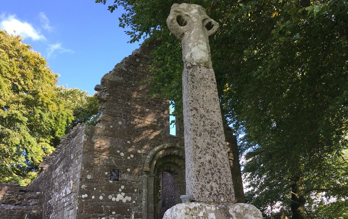 Ancient stone cross sitting atop a more modern base, outside Monaincha abbey, Roscrea | Photo (c) Tipp FM/MaryAnn Vaughan