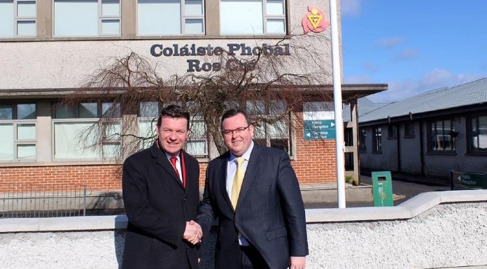 Alan Kelly TD with Colaiste Phobal Principal Michael O’Connor. (Photo taken prior to the pandemic)