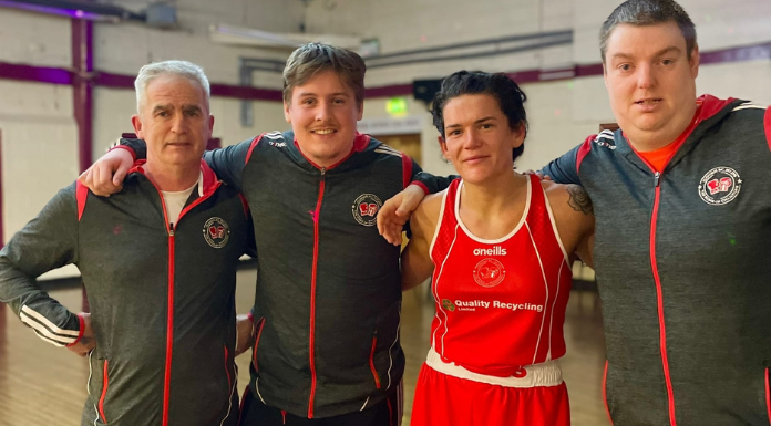 Shauna O'Keeffe pictured with her team from Clonmel Boxing Club. Photo from Martin Fennessy's Facebook page via Canva.com.